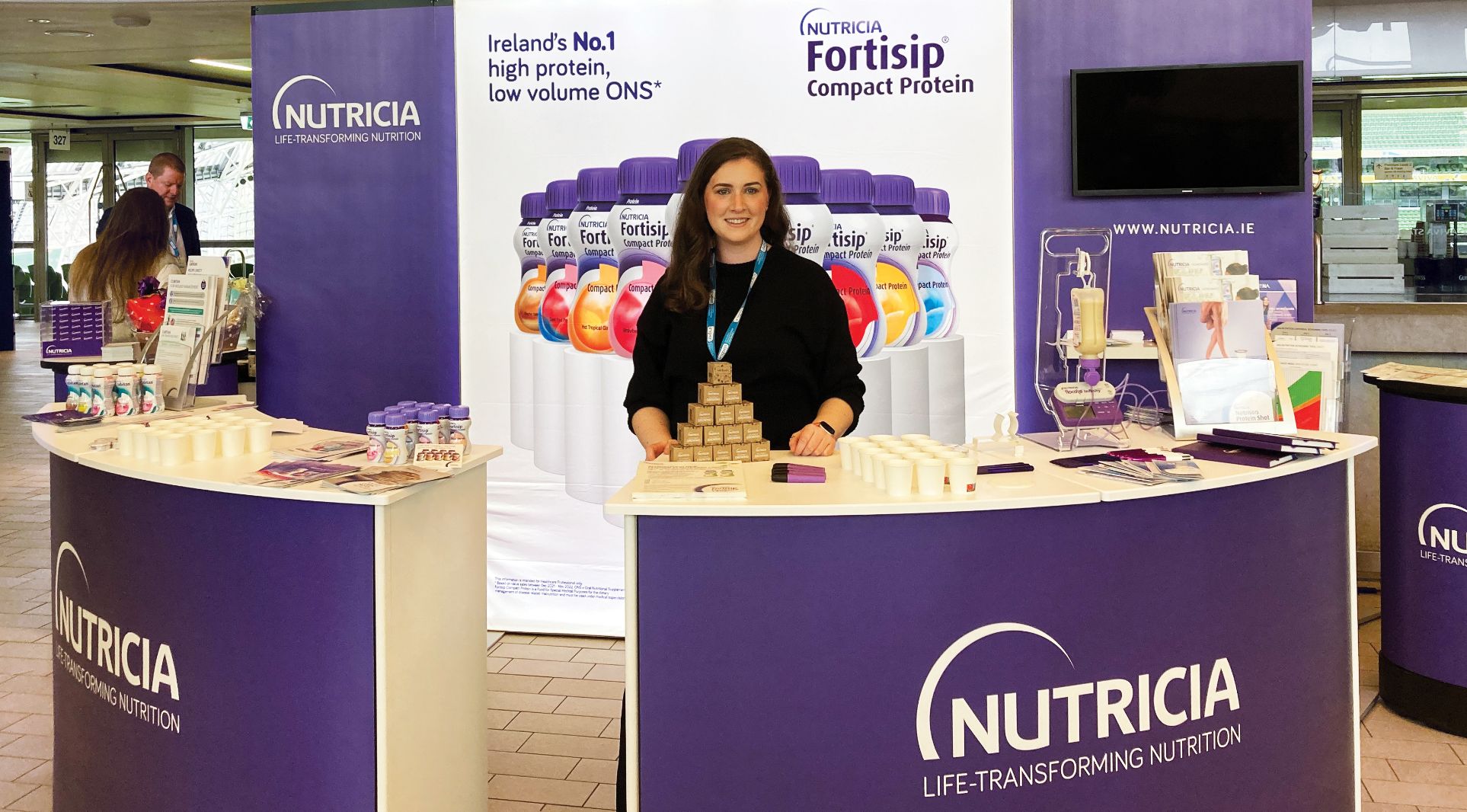 Woman in Nutricia stand